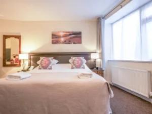 Hotel bedroom with double bed and patterned bedspread